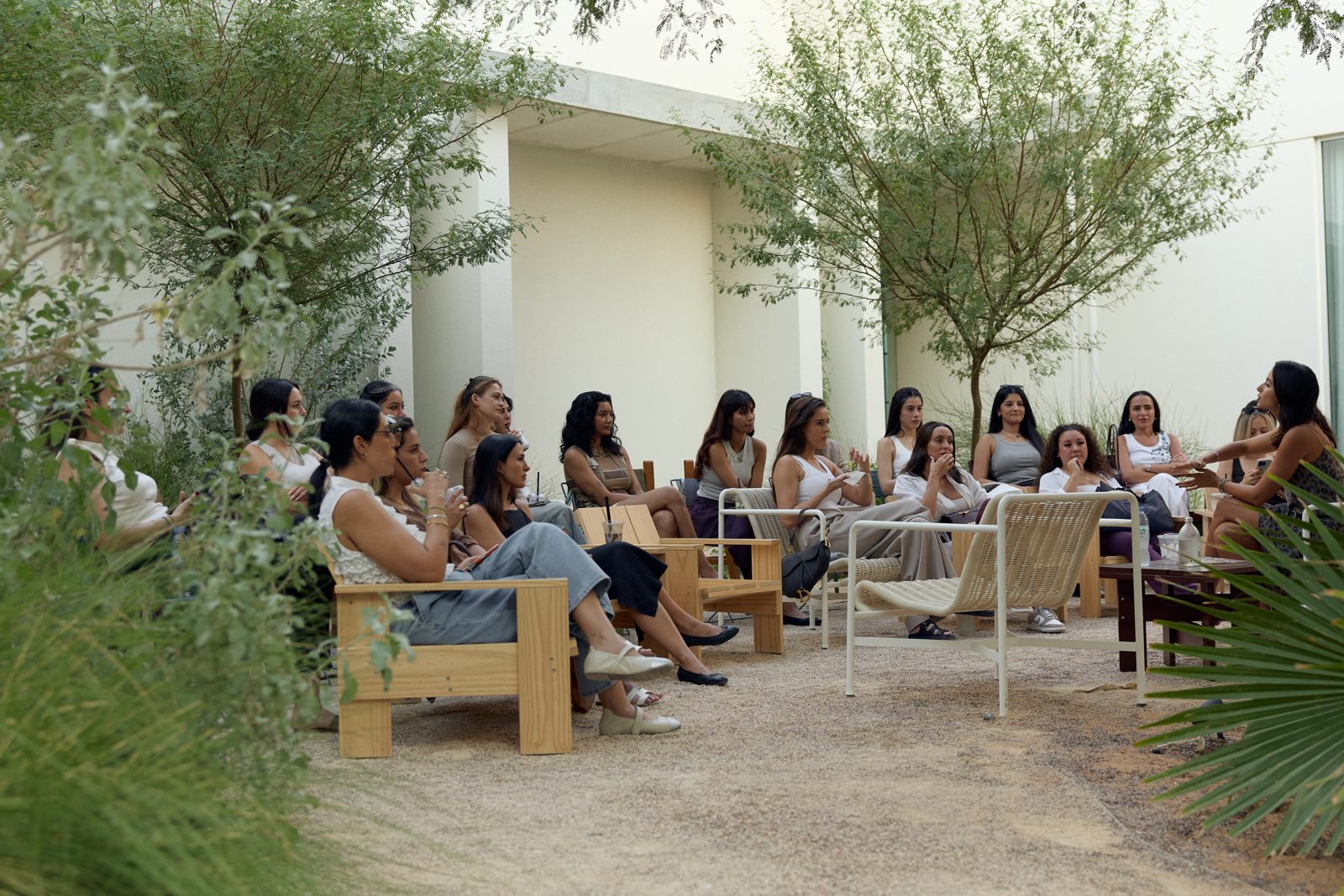 Mint Elmokadm speaking with a circle of women in a garden